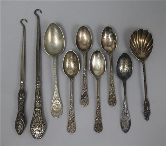 Two silver handled button hooks, a sterling silver teaspoon, a silver preserve spoon and five plated spoons.